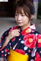 A woman in a kimono is posing for a picture.