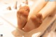 A close up of a woman's feet in a bathtub.